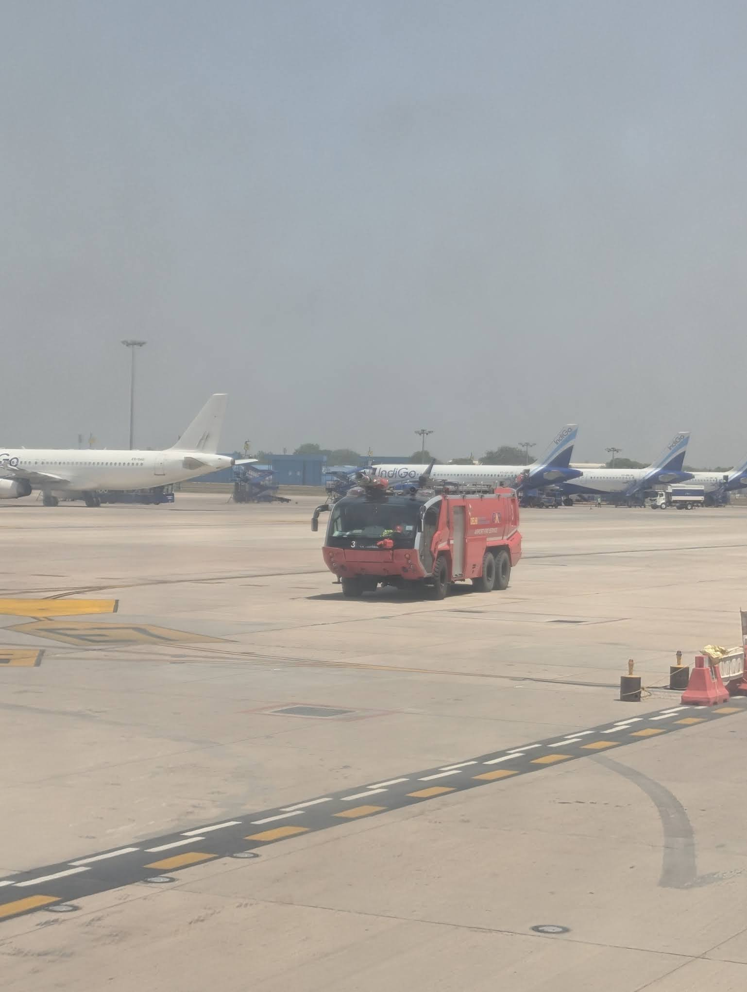 Fire trucks escorting the plane on the runway